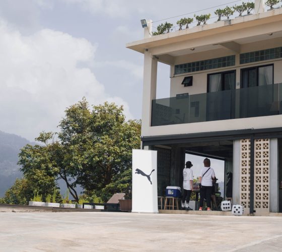 Exterior view of Hillcrest Dawn villa featuring a Puma branded banner set up for a corporate team building retreat in Bentong