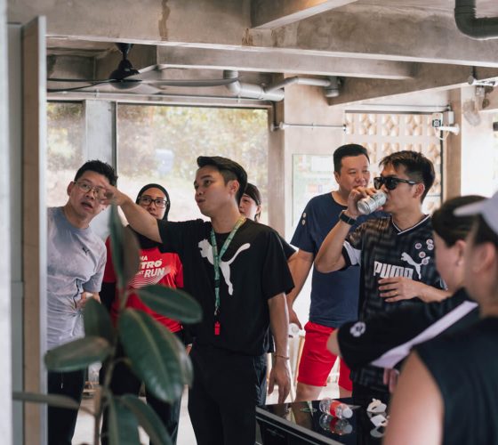 Team building facilitator giving an activity briefing to Puma team members during a corporate retreat at Hillcrest Dawn